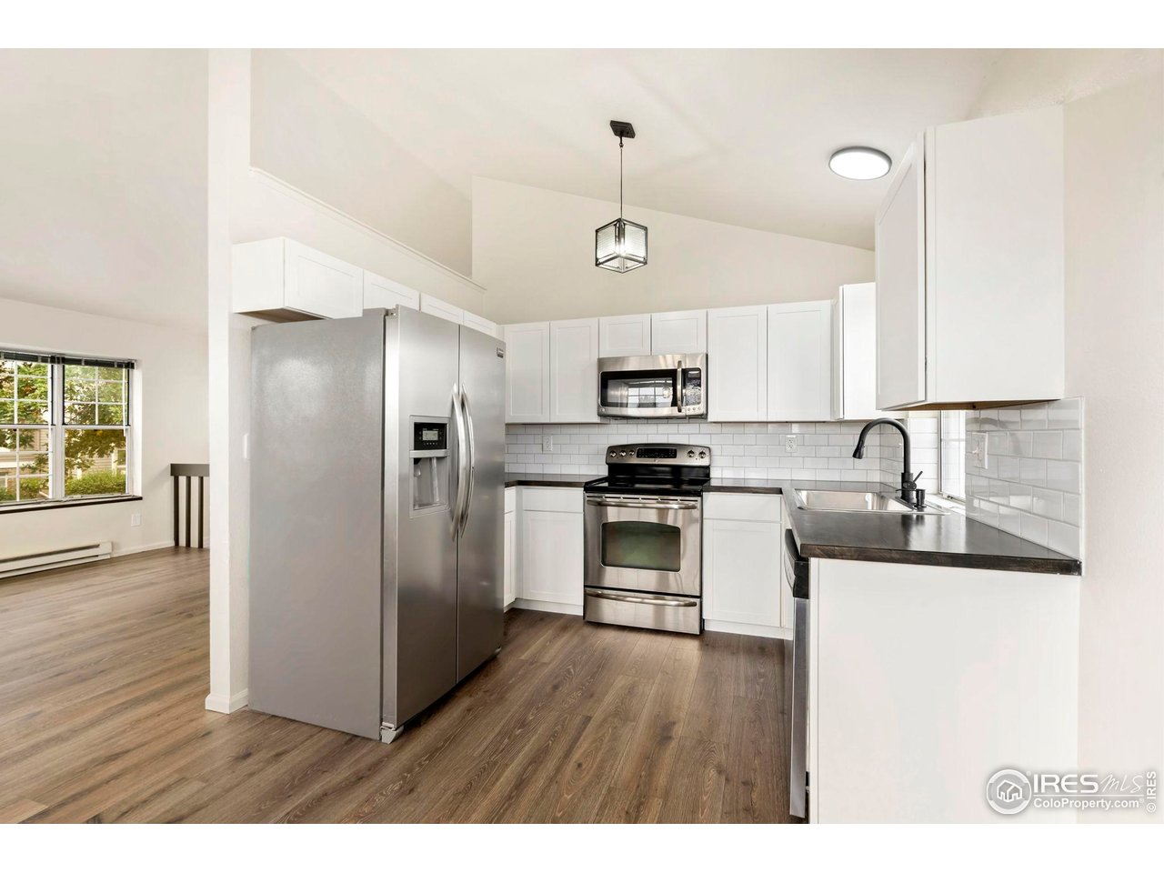 2828 Silverplume Drive, Unit R3 Fort Collins, CO 80526 - Photo 11 of 45 a kitchen with stainless steel appliances kitchen island a refrigerator sink and cabinets