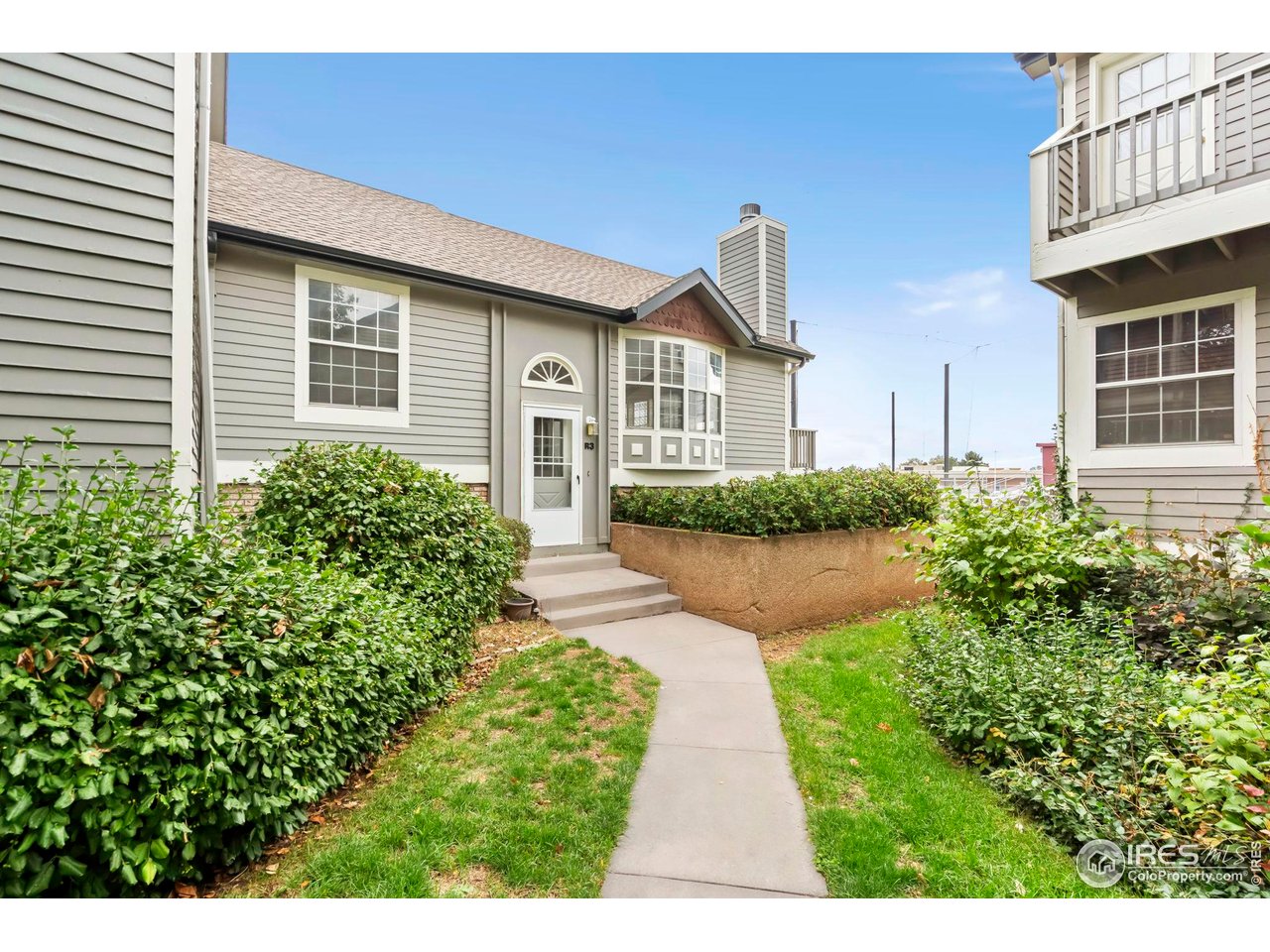 2828 Silverplume Drive, Unit R3 Fort Collins, CO 80526 - Photo 42 of 45 a front view of a house with a yard and potted plants
