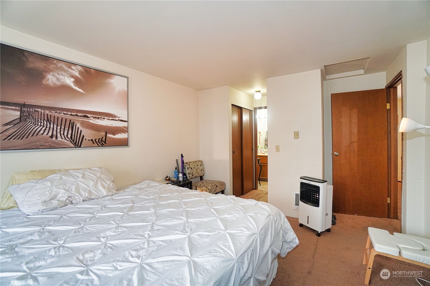 24914 109th Place Southeast, Unit 34C Kent, WA 98030 - Photo 16 of 38 a bedroom with a bed and painting on the wall