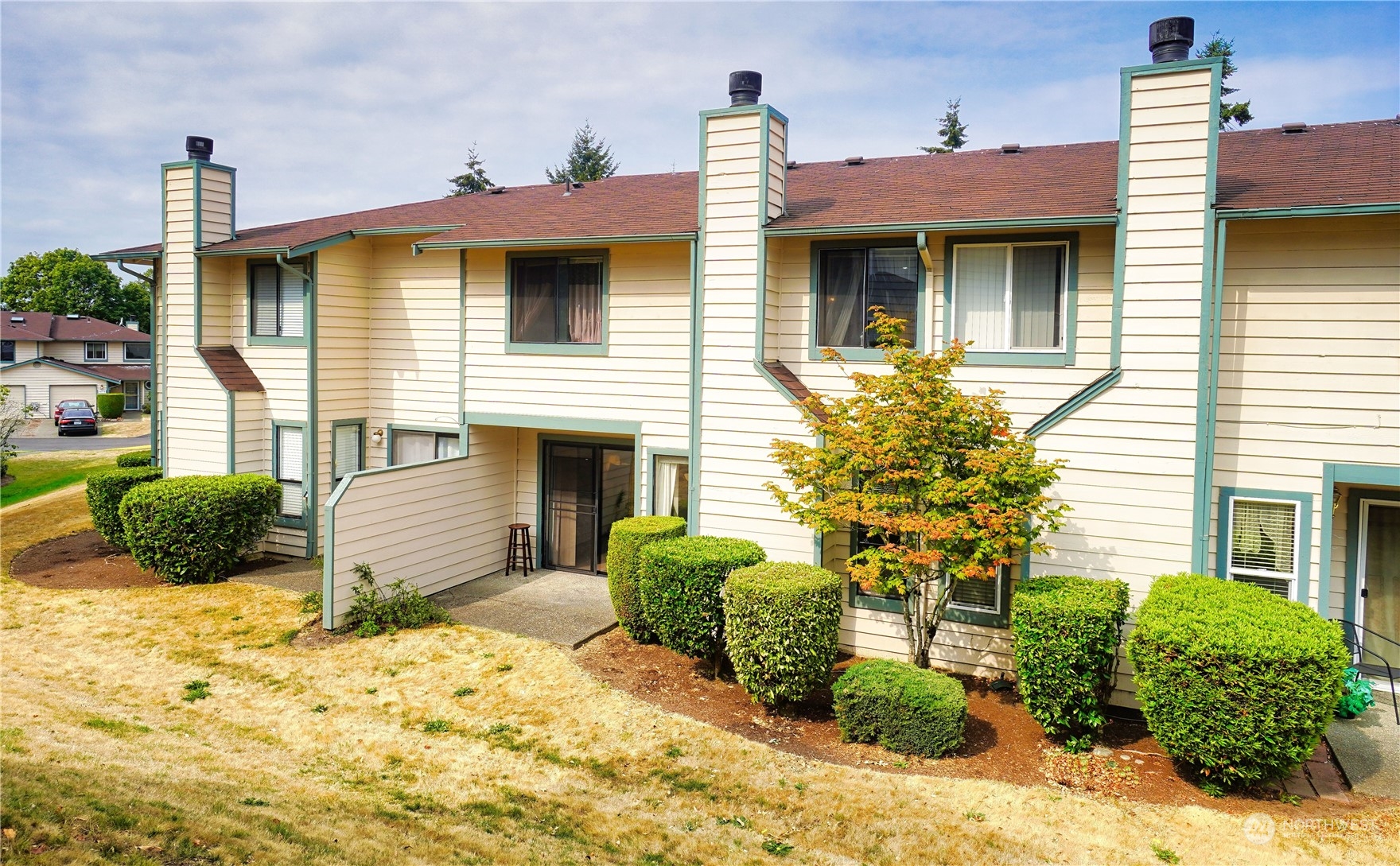 24914 109th Place Southeast, Unit 34C Kent, WA 98030 - Photo 31 of 38 a view of a house with a yard and potted plants