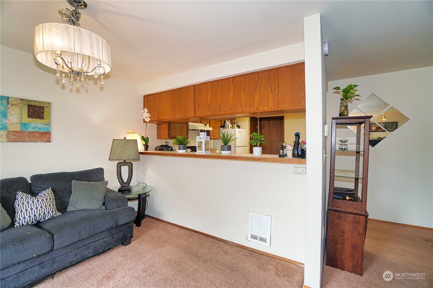 24914 109th Place Southeast, Unit 34C Kent, WA 98030 - Photo 10 of 38 a living room with furniture a chandelier and a dining table