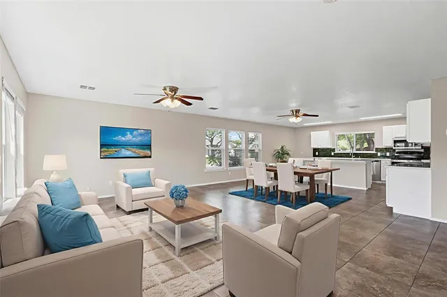 a living room with furniture and kitchen view