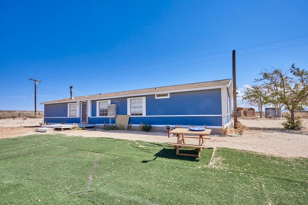 29873 Ranchito Road Helendale, CA 92342 - Photo 1 of 1 a backyard of a house with table and chairs