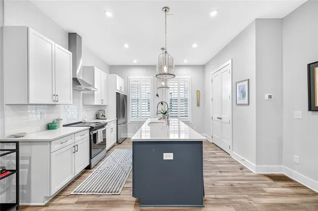 a kitchen with a sink stove and cabinets