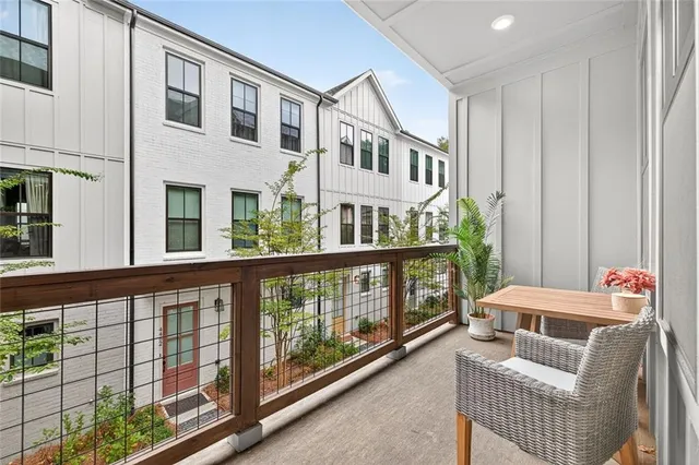a large bed sitting in a bedroom next to a window and a lamp