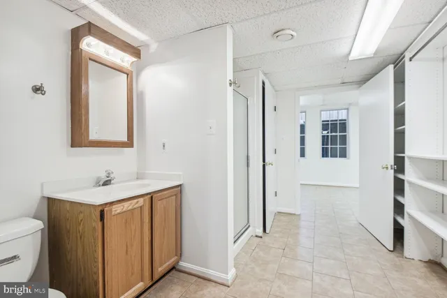 a bathroom with a sink a toilet and mirror