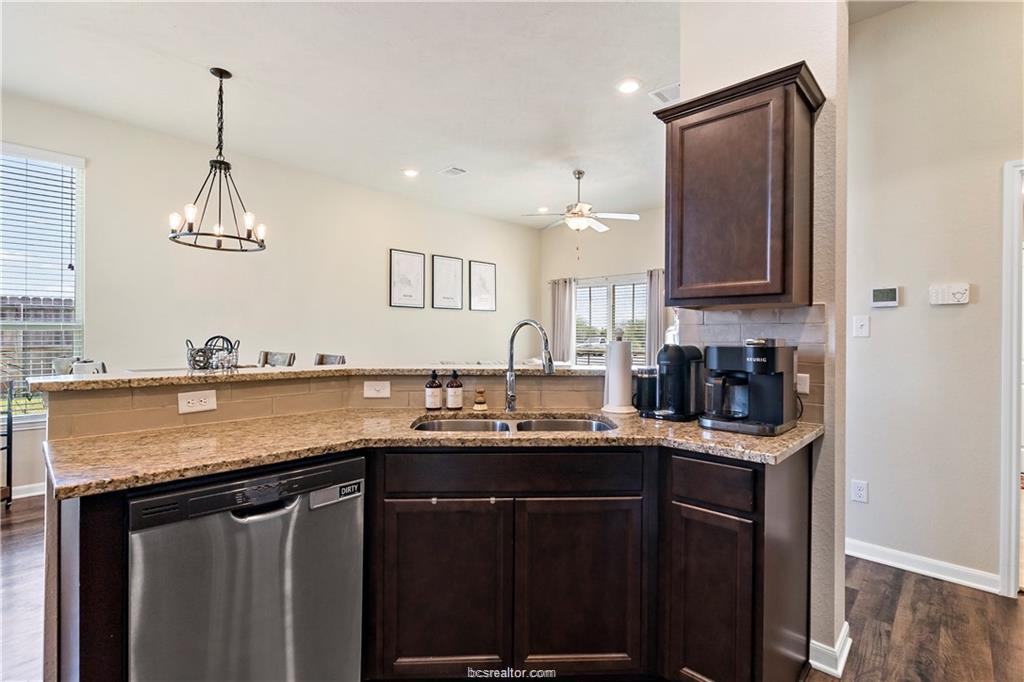 2000 Bleeker Cove Bryan, TX 77807 - Photo 13 of 24 a kitchen with stainless steel appliances granite countertop a sink stove and cabinets