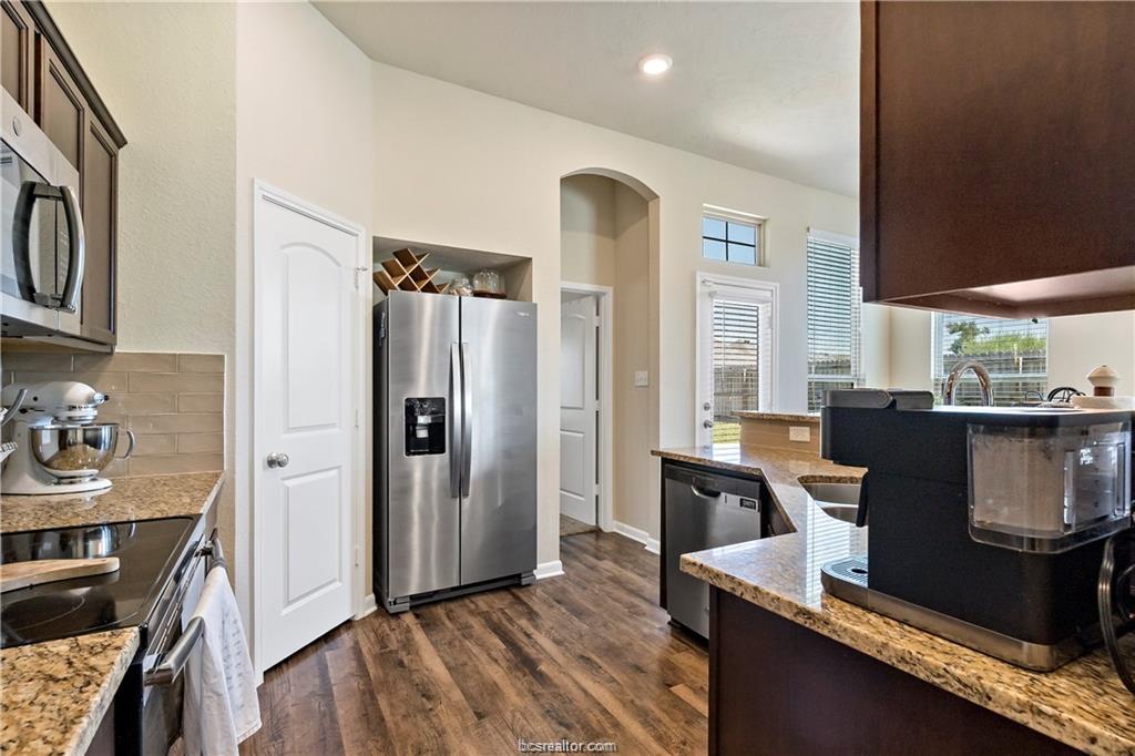 2000 Bleeker Cove Bryan, TX 77807 - Photo 15 of 24 a kitchen with stainless steel appliances granite countertop a refrigerator and a stove top oven