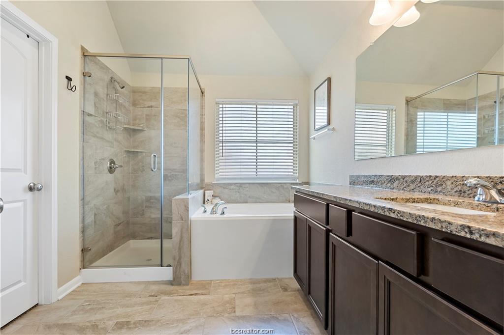 2000 Bleeker Cove Bryan, TX 77807 - Photo 17 of 24 a bathroom with a granite countertop sink a toilet and shower
