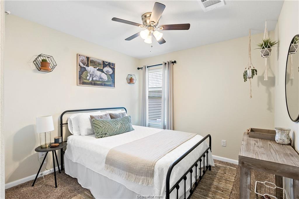 2000 Bleeker Cove Bryan, TX 77807 - Photo 19 of 24 a bedroom with a bed and a chandelier