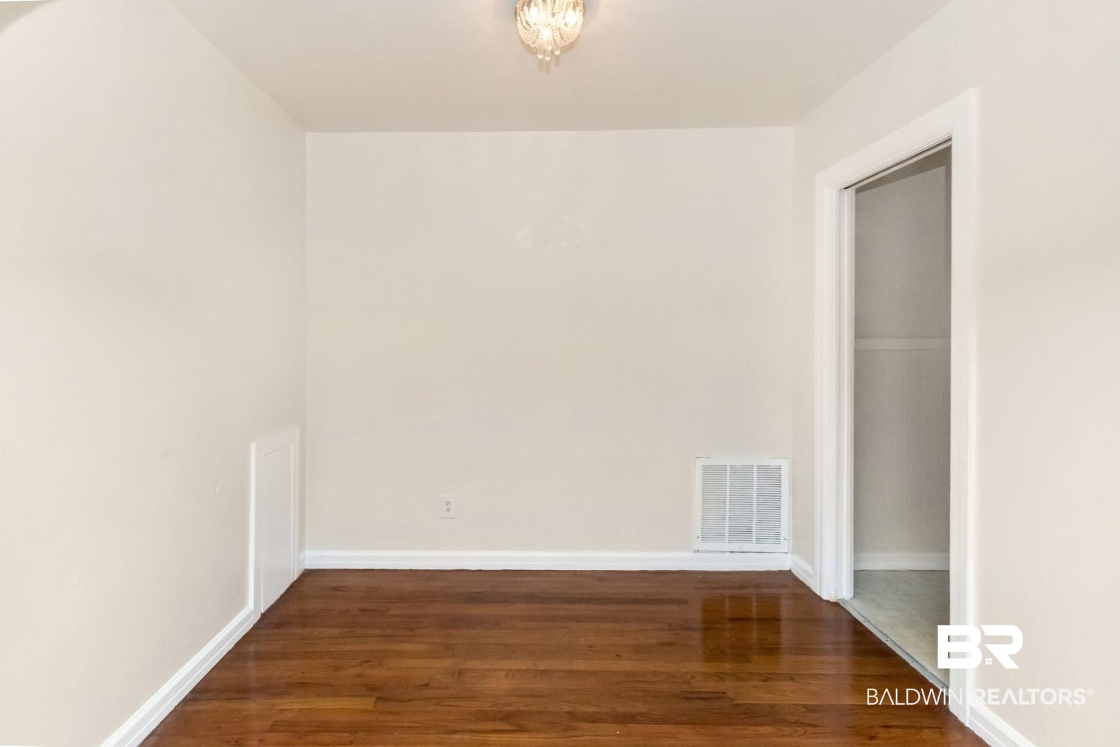 1477 Fairfield Street Mobile, AL 36606 - Photo 12 of 34 Spare room with dark wood-style flooring and baseboards