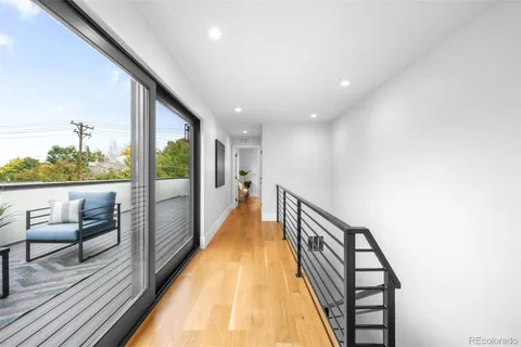 a view of a hallway with furniture