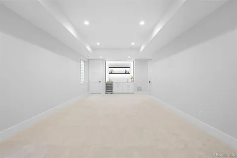 an empty room with white walls and windows