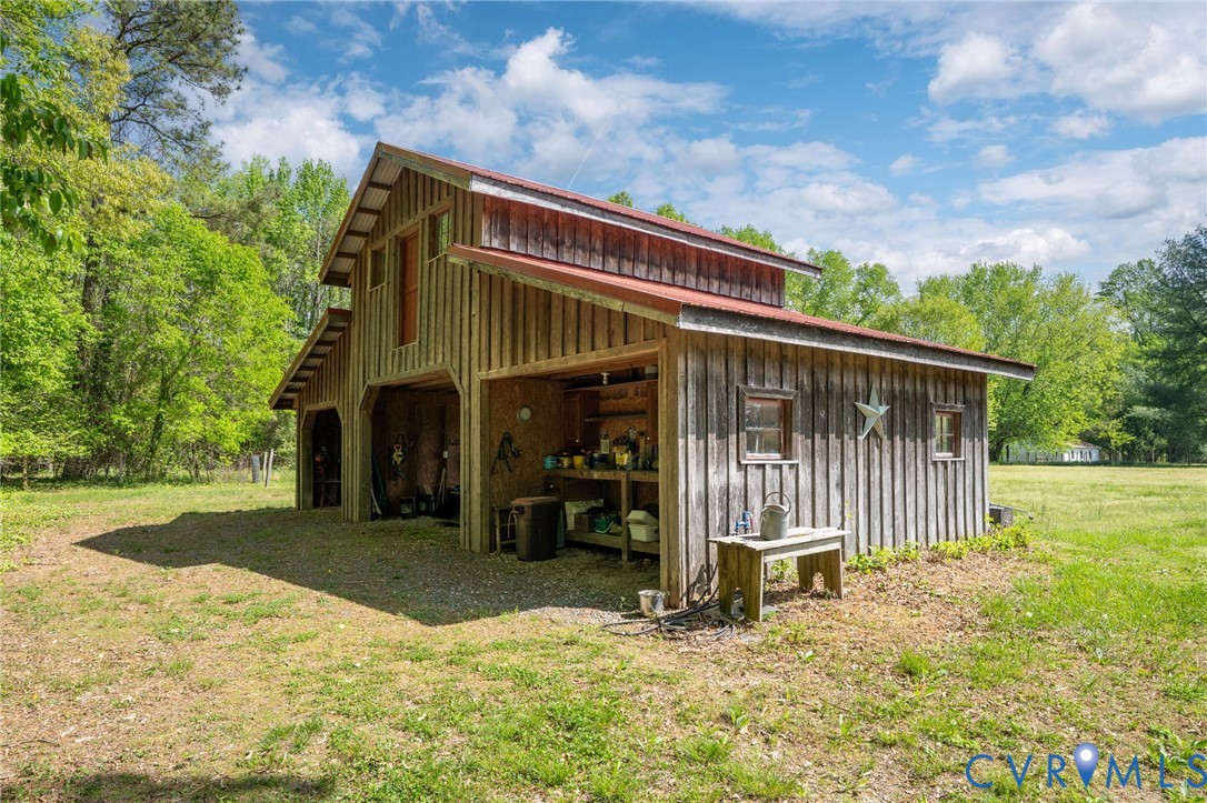 7381 McClellan Road Mechanicsville, VA 23111 - Photo 8 of 66 Two-story barn with wood siding and a red metal ro