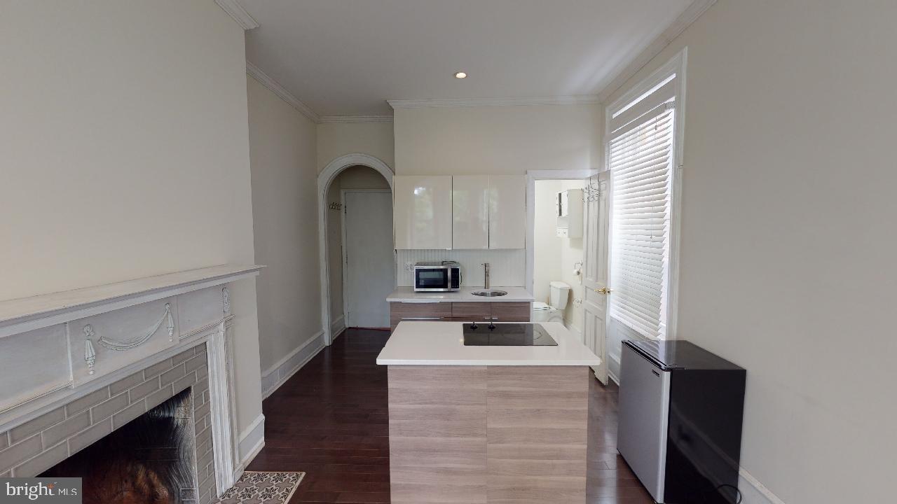 2312 Locust Street, Unit 2R Philadelphia, PA 19103 - Photo 3 of 13 a kitchen with granite countertop a stove and a refrigerator