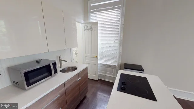 a kitchen with sink and cabinets