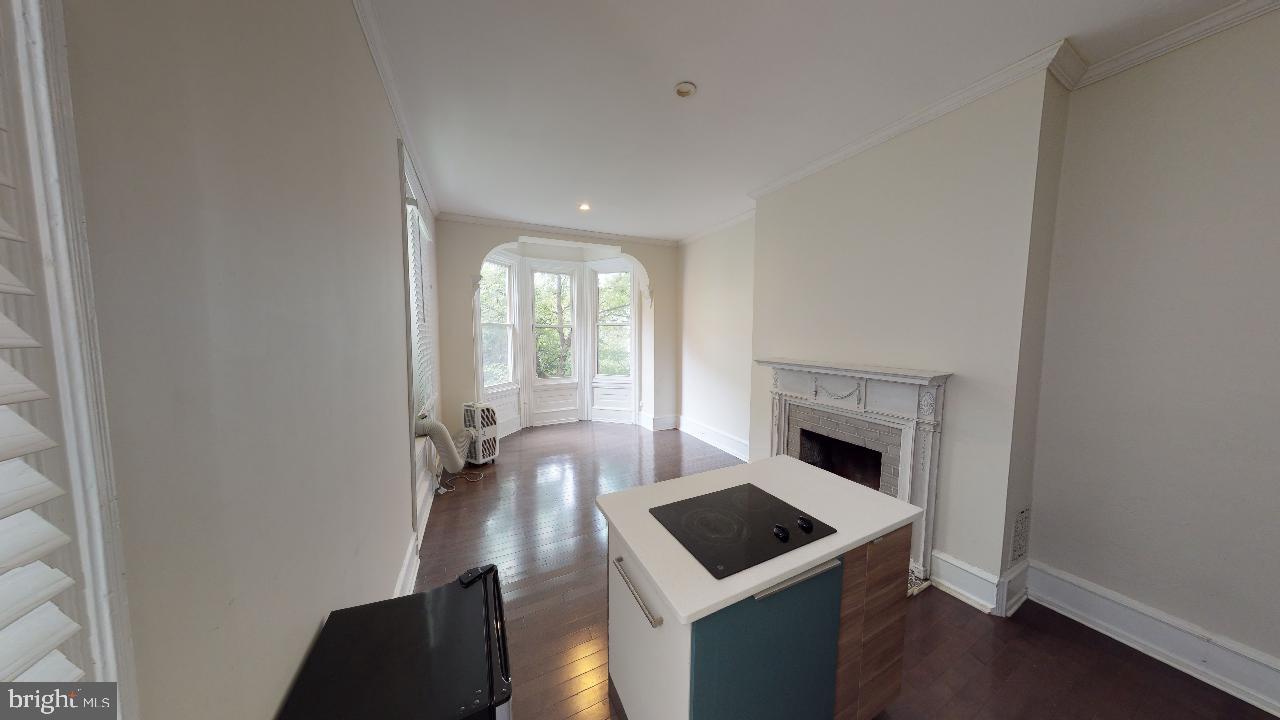 2312 Locust Street, Unit 2R Philadelphia, PA 19103 - Photo 7 of 13 a living room with furniture and a fireplace