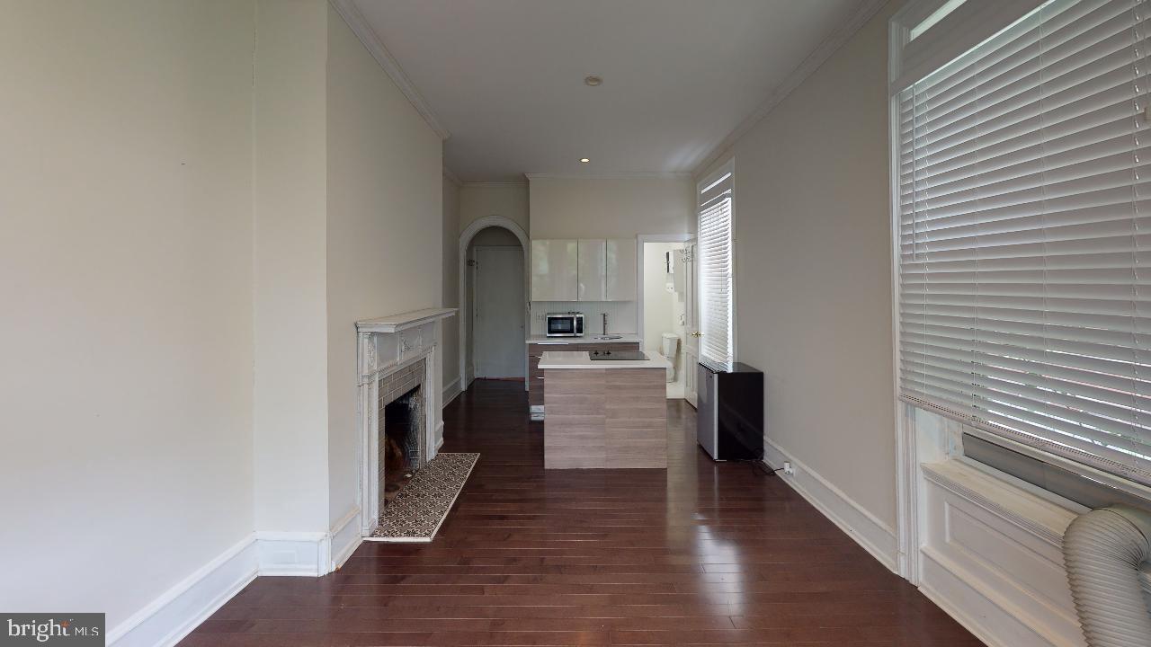 2312 Locust Street, Unit 2R Philadelphia, PA 19103 - Photo 9 of 13 a view of a hallway with wooden floor and staircase