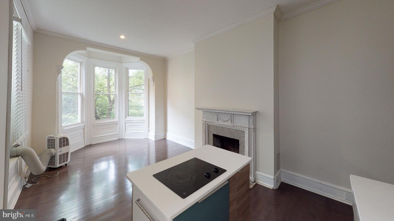 2312 Locust Street, Unit 2R Philadelphia, PA 19103 - Photo 10 of 13 a living room with furniture and a fireplace
