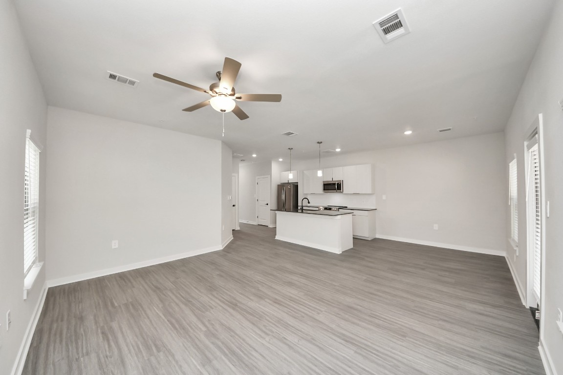 7711 Longmire Road, Unit 155 Conroe, TX 77304 - Photo 46 of 48 Boasting luxury finishes-stylish Island kitchen,granite counters,subway tile backsplash,ample custom cabinet space,stainless appliances,refrigerator,full size washer&dryer included,wood-like floors throughout,open concept floor plan.