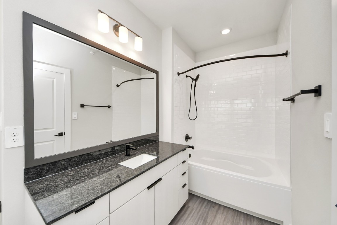 7711 Longmire Road, Unit 155 Conroe, TX 77304 - Photo 20 of 48 Primary Suite offers walk-closet,bath w/granite vanity&lux tub/shower.