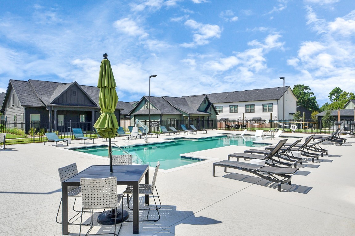 7711 Longmire Road, Unit 155 Conroe, TX 77304 - Photo 2 of 48 Enjoy an abundance of Amenities:Resort-Style Pool w/Sundeck Ledge&Outdoor Lounge Areas w/Grilling area,Gaming Lawn,Pickleball Court,Quaint Dog Park for your fur babies!24/7 Fitness Center w/Kids Play Zone area.Stunning Clubhouse w/Café/Lounge.Playground Area.Electric Vehicle Charging Stations!