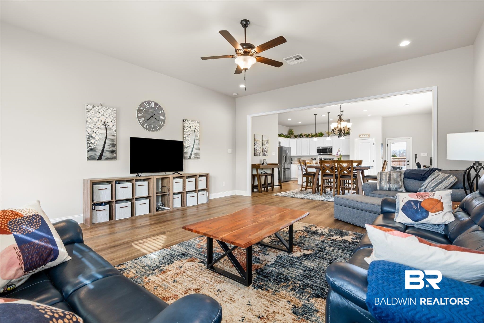 1116 Stella Road Foley, AL 36535 - Photo 4 of 29 Living room with ceiling fan with notable chandelier and wood-type flooring