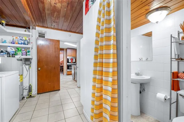 a spacious bedroom with a large bed and a chandelier