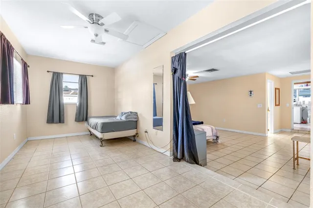 a bedroom with a bed and a tv