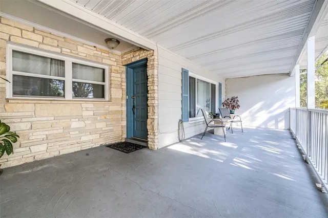 a view of a patio with table and chairs and potted plants
