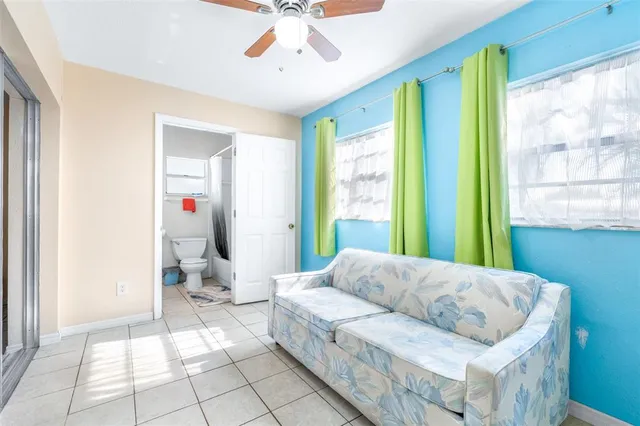 a white toilet sitting next to a bathroom sink and vanity