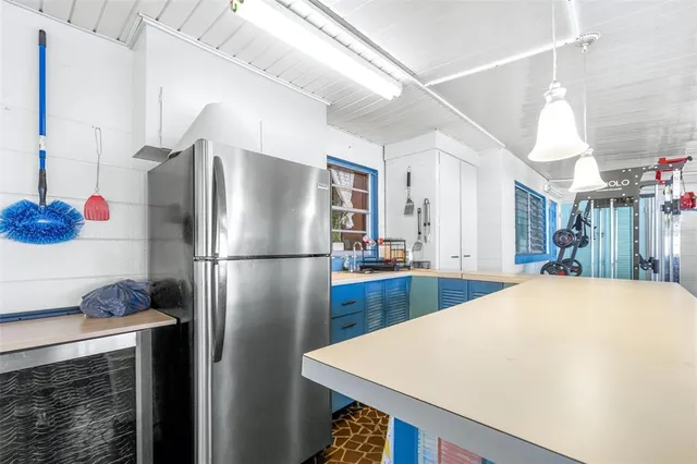 a living room with patio furniture and a table