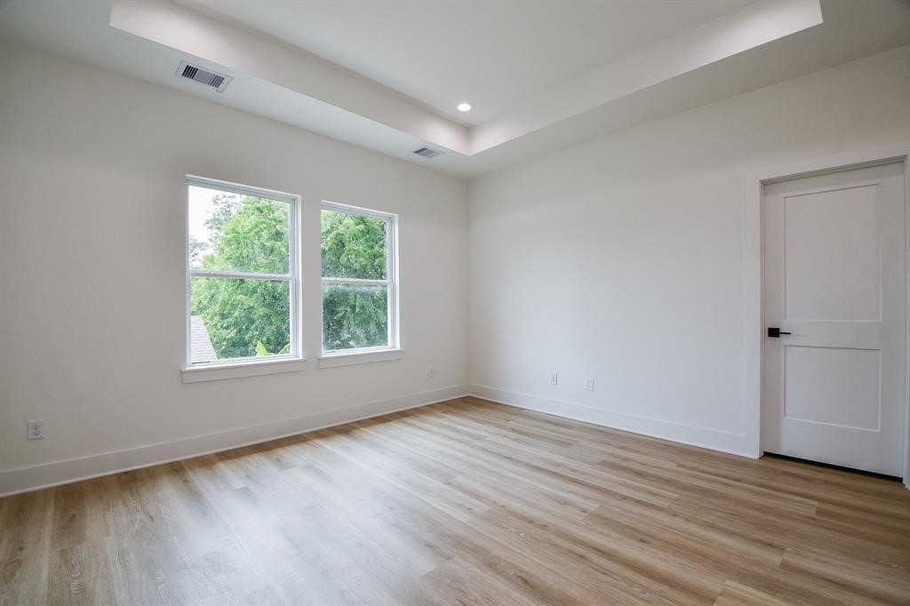 2305 Maury Street Houston, TX 77026 - Photo 9 of 19 Upstairs, the primary bedroom offers a tranquil retreat with a spacious walk-in shower, double vanity, and a luxurious soaking tub, providing the ultimate relaxation after a long day.
This home is equipped with modern conveniences, including large walk-in closets, charming shiplap accent walls.