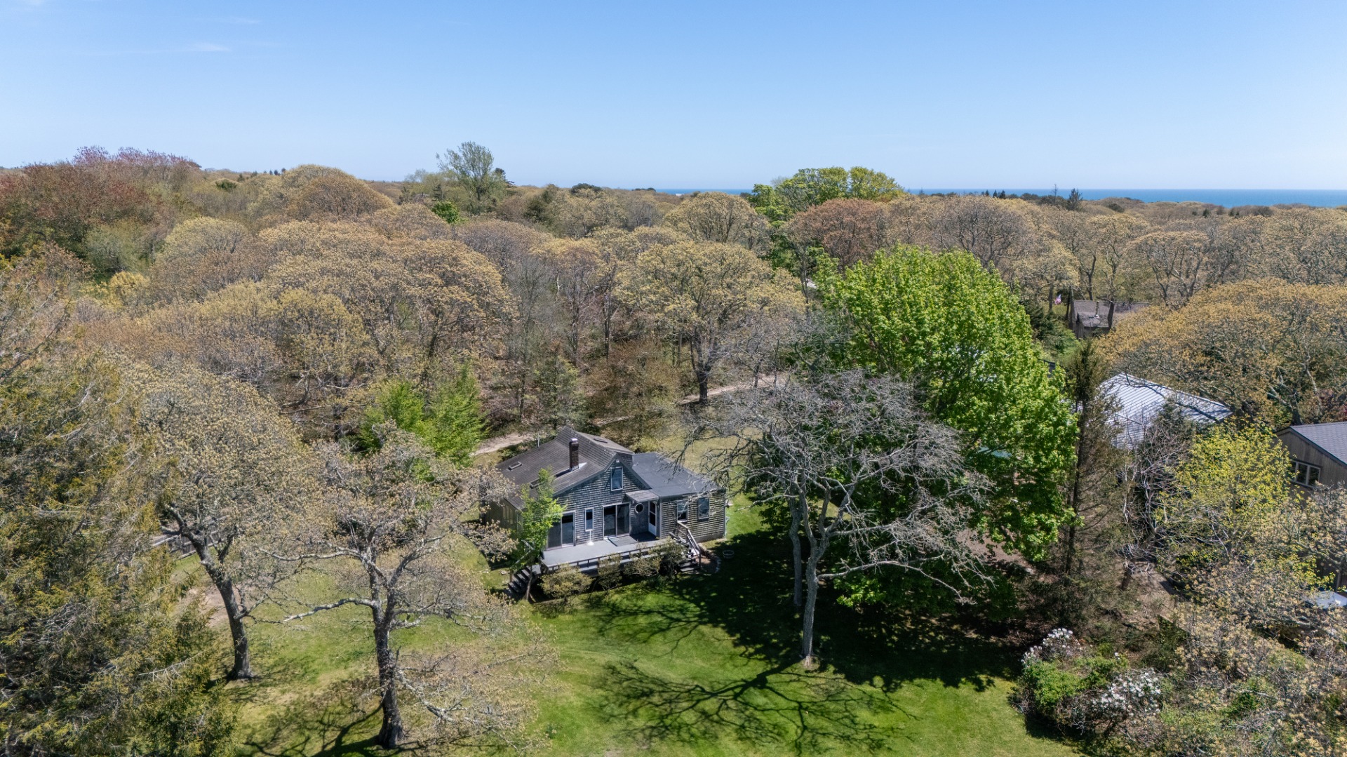 10 Abel's Neck Road Chilmark, MA 02535 - Photo 19 of 20 a view of a house with a mountain and a forest