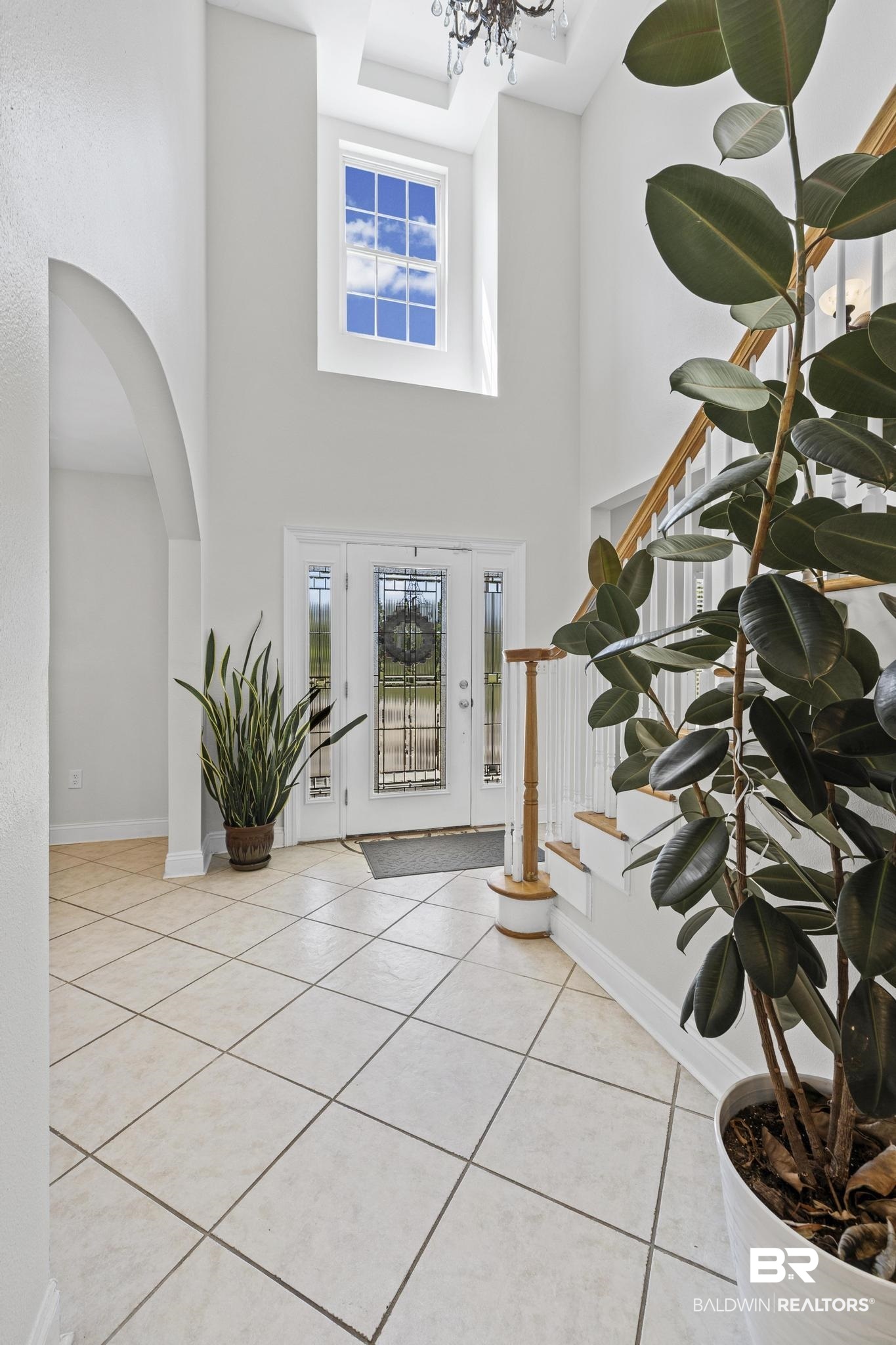 32875 Faircloth Road Lillian, AL 36549 - Photo 17 of 85 Entryway with arched walkways, light tile patterned floors, a high ceiling, and hanging lights