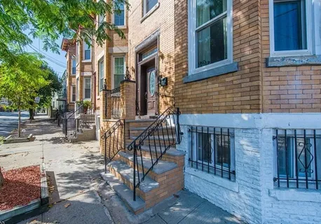 a view of a brick house with many windows