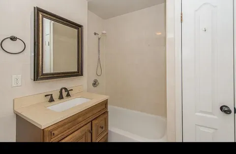 a bathroom with a sink mirror and vanity