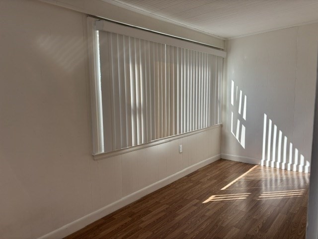 45 Webster Street, Unit 2 Woburn, MA 01801 - Photo 9 of 10 an empty room with wooden floor and windows