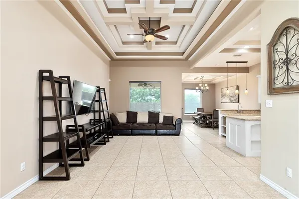 a living room with furniture a window and a chandelier