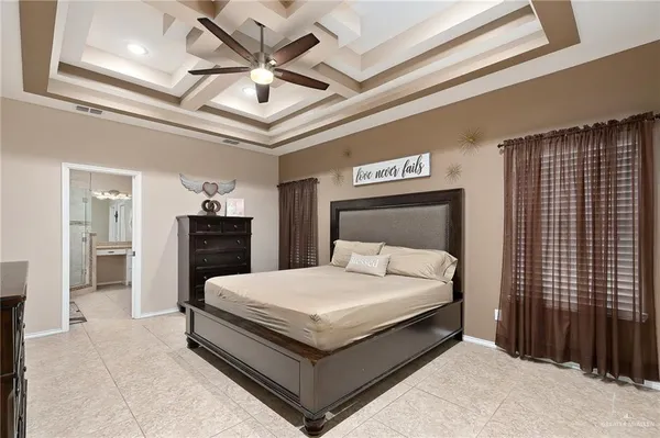 a large bed sitting in a bedroom next to a bathroom