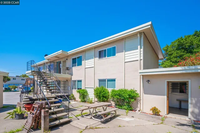 a front view of a house with lots of green space