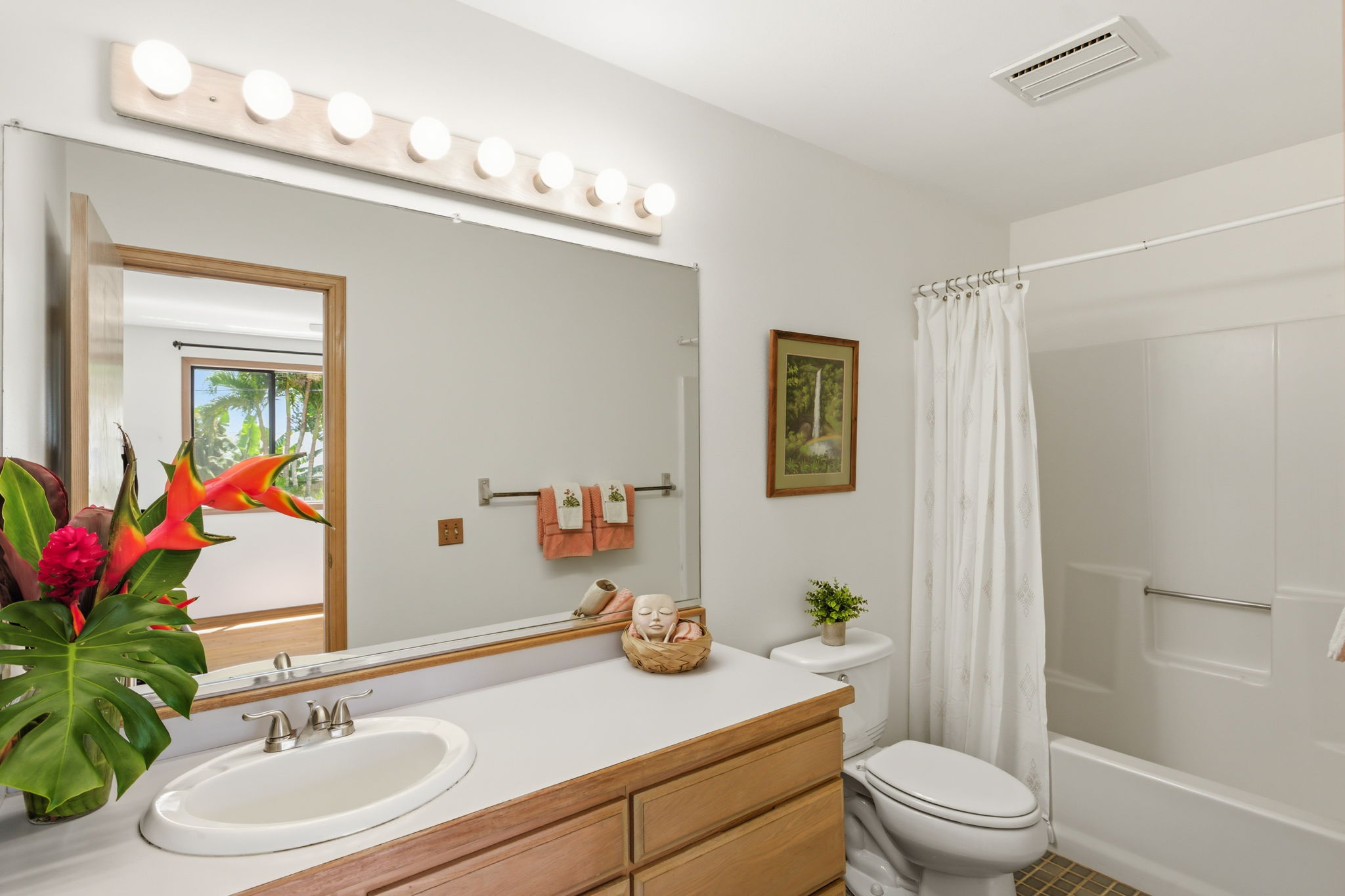 3685 Waha Road Kalaheo, HI 96741 - Photo 23 of 30 a bathroom with a granite countertop sink a toilet a mirror a vanity and shower