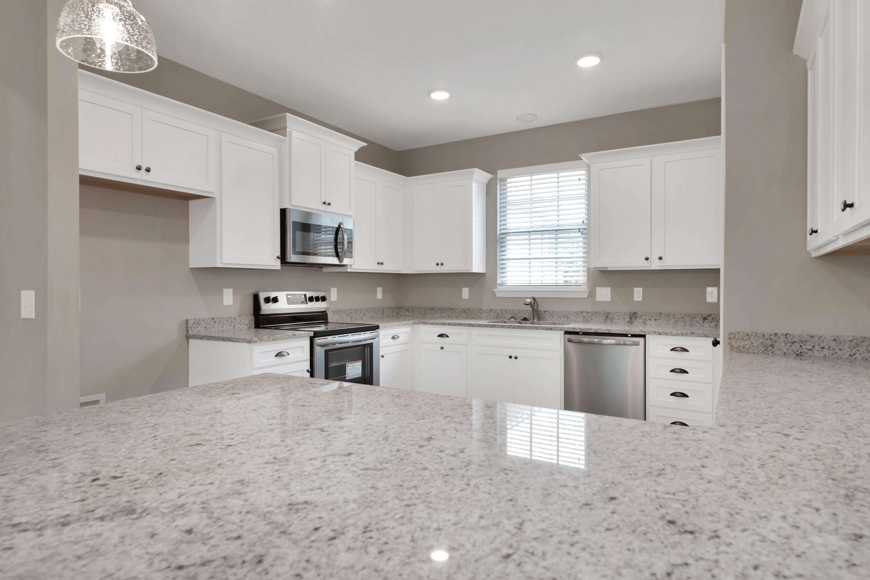 6195 Timberland Ridge Drive Crestview, FL 32539 - Photo 12 of 39 a kitchen with stainless steel appliances granite countertop a stove top oven a sink a refrigerator and white cabinets