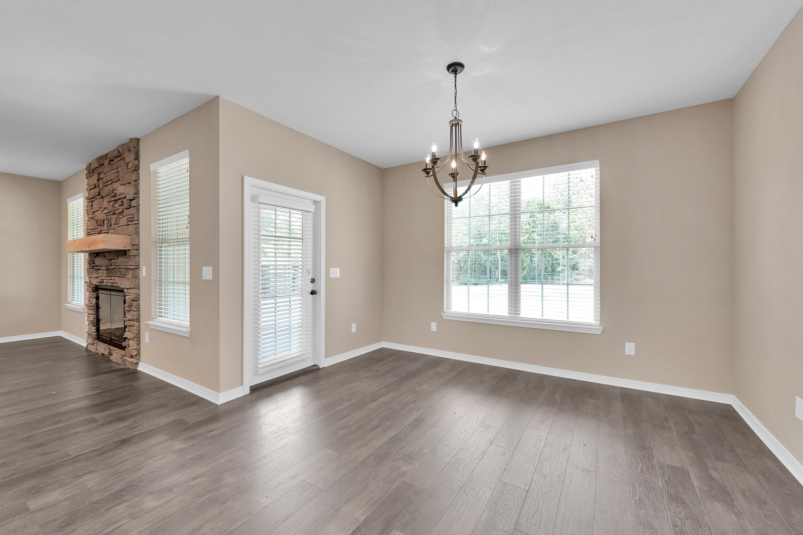 6195 Timberland Ridge Drive Crestview, FL 32539 - Photo 16 of 39 a view of an empty room with window and wooden floor