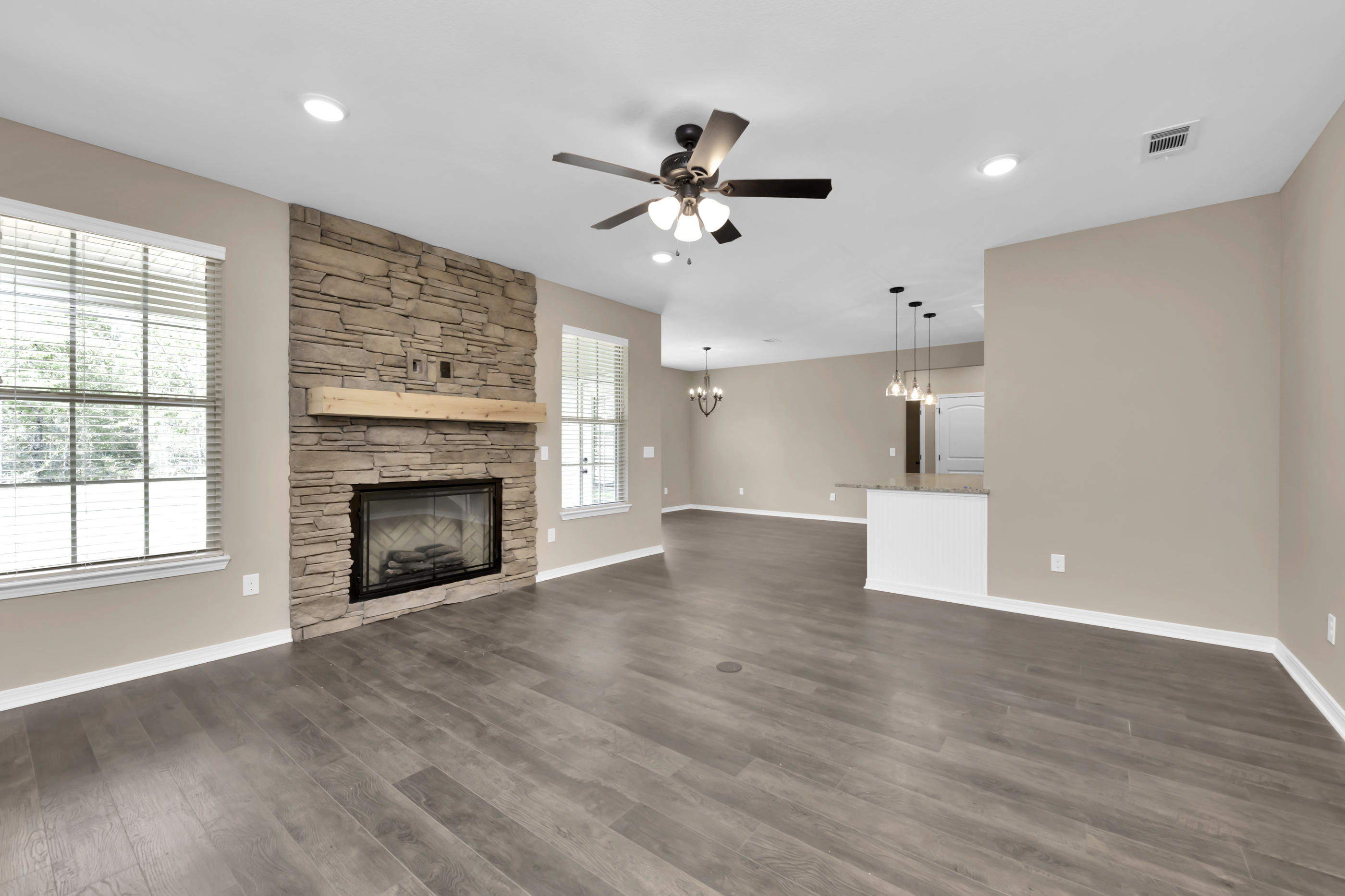 6195 Timberland Ridge Drive Crestview, FL 32539 - Photo 20 of 39 a view of empty room with wooden floor fireplace and window