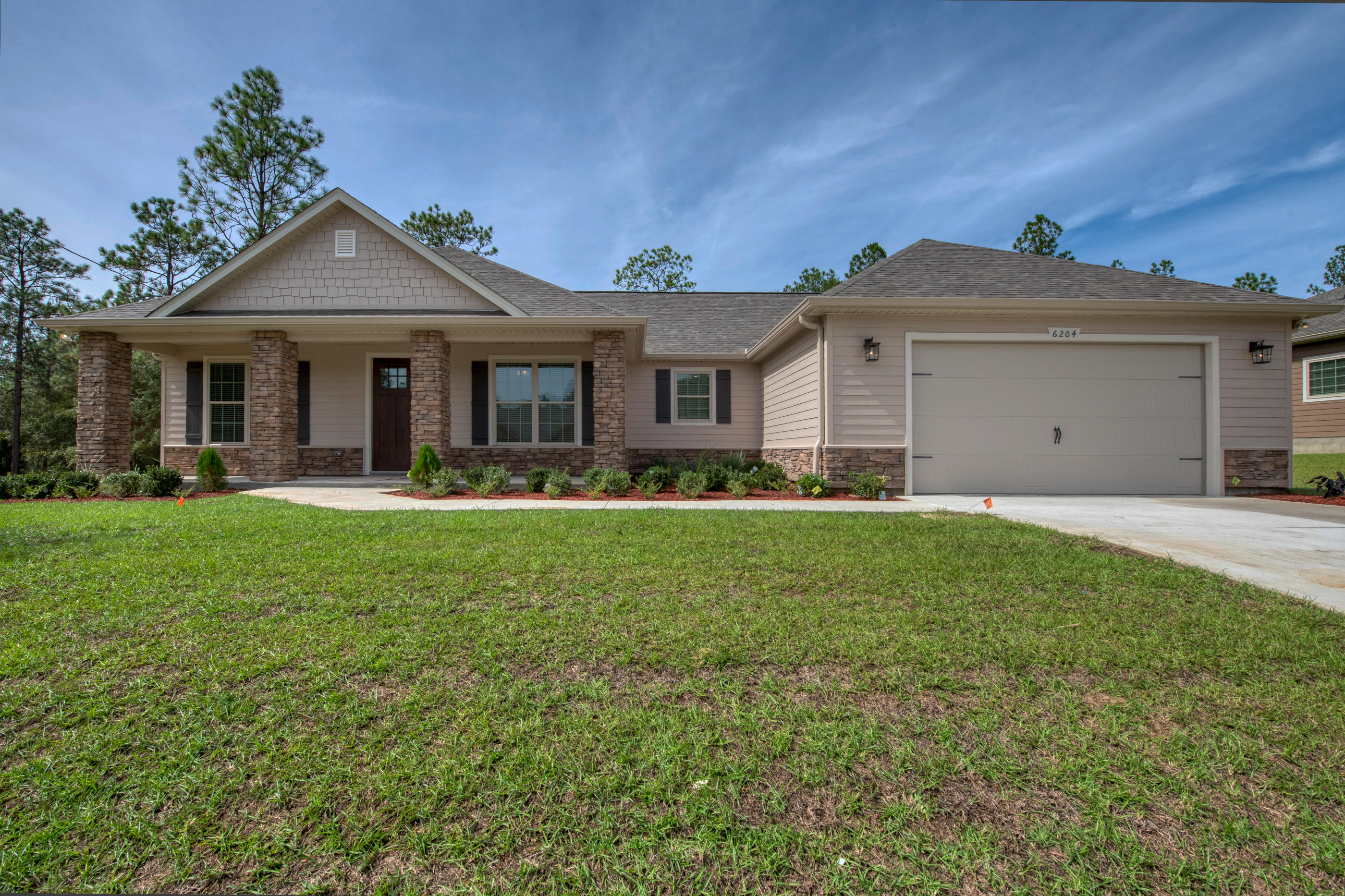 6195 Timberland Ridge Drive Crestview, FL 32539 - Photo 2 of 39 a front view of a house with garden