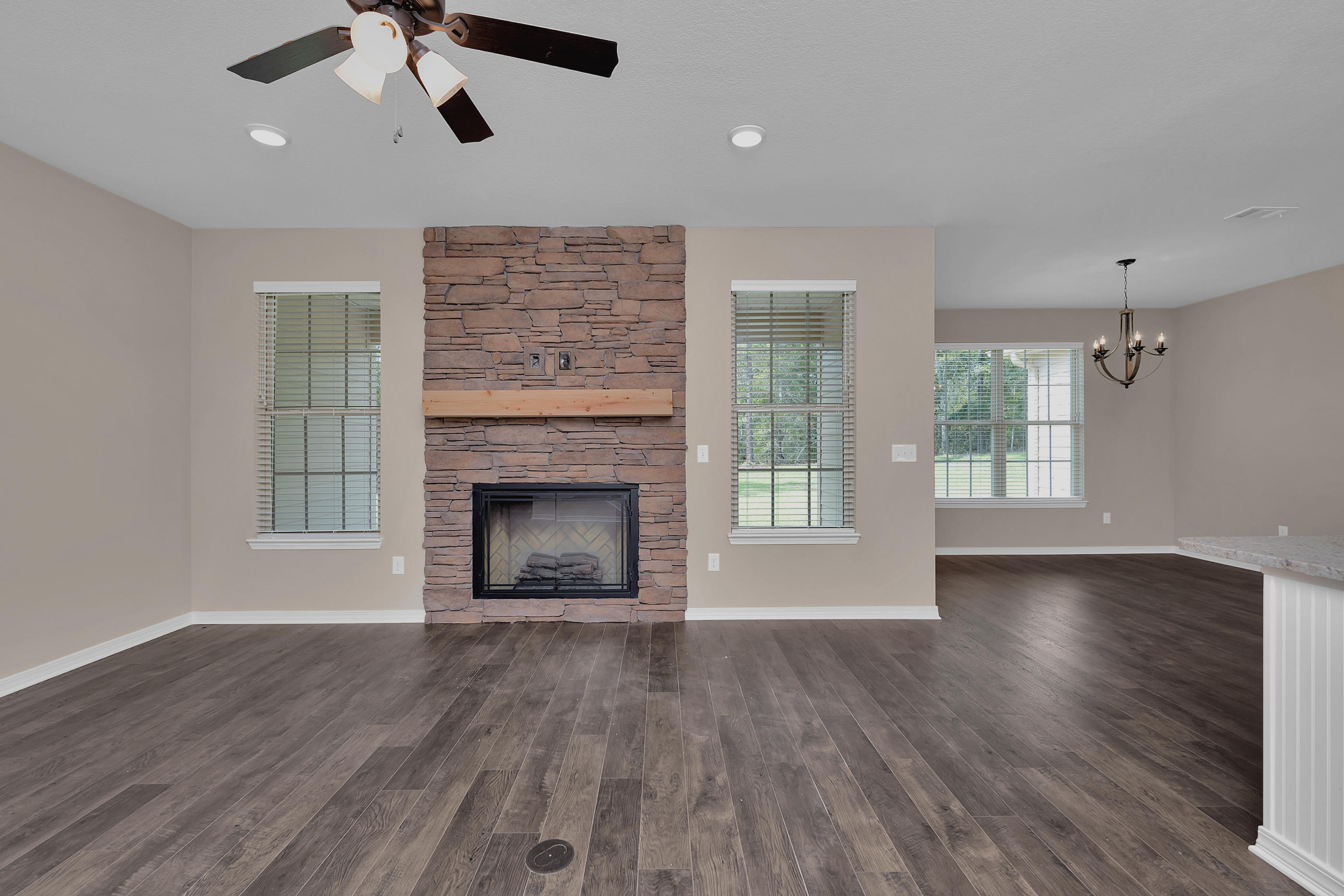 6195 Timberland Ridge Drive Crestview, FL 32539 - Photo 21 of 39 a view of an empty room with wooden floor fireplace and a window