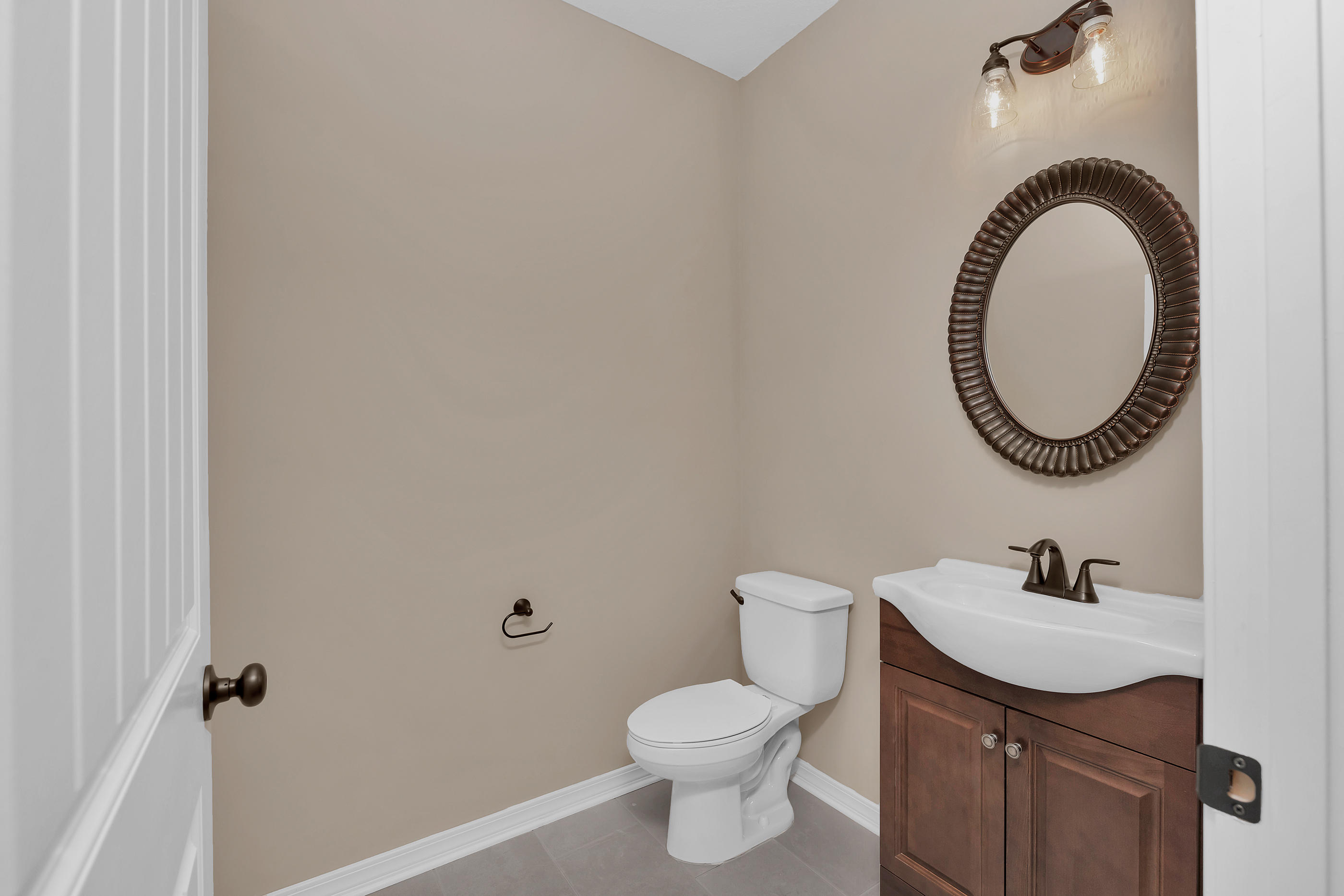 6195 Timberland Ridge Drive Crestview, FL 32539 - Photo 23 of 39 a bathroom with a sink a toilet and a mirror
