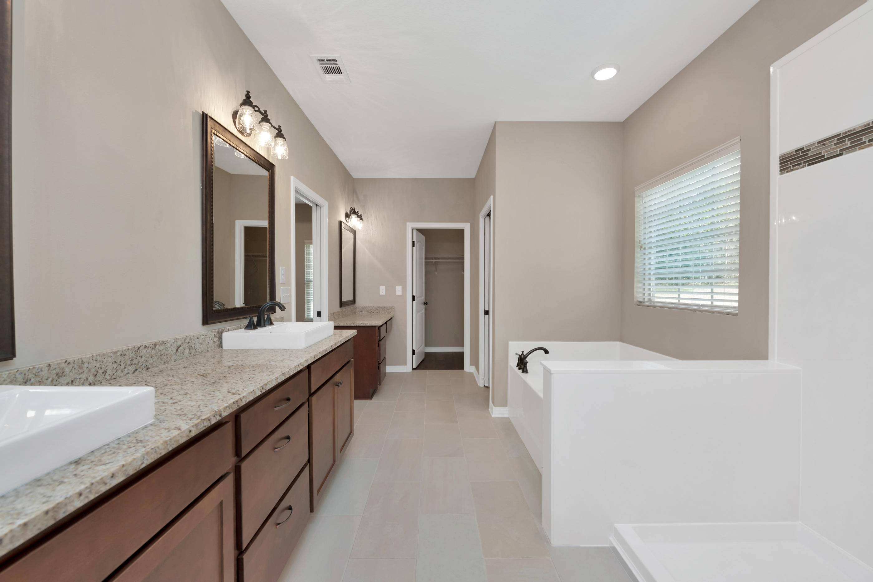 6195 Timberland Ridge Drive Crestview, FL 32539 - Photo 27 of 39 a bathroom with a granite countertop sink mirror and bathtub