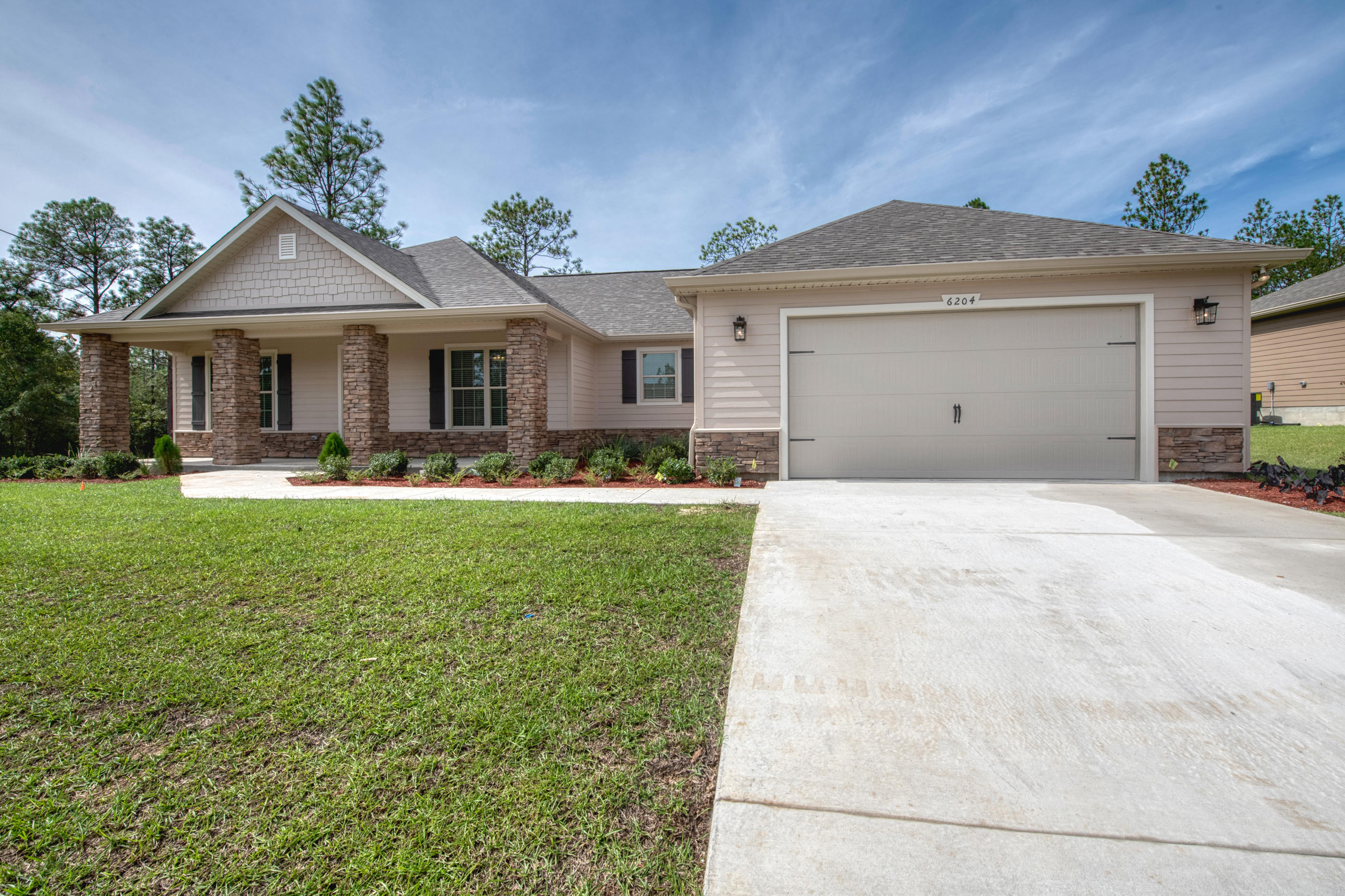 6195 Timberland Ridge Drive Crestview, FL 32539 - Photo 3 of 39 a front view of a house with garden